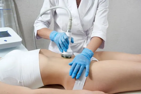 Lost the Weight but Not the Loose Skin? 2 woman having HIFU treatment on her stomach to combat loose skin Warwickshire following weight loss